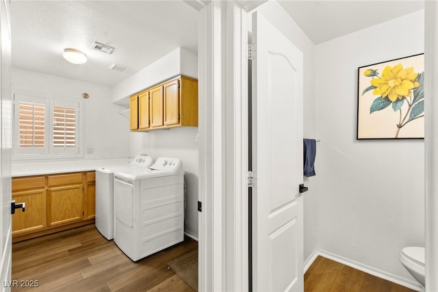 8612 Danza Del Sol Dr, Las Vegas, NV 89128 - laundry area with wood finished floors, washer and dryer, and cabinet space
