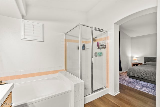 8612 Danza Del Sol Dr, Las Vegas, NV 89128 - full bathroom featuring wood finished floors, a stall shower, a bath, ensuite bath, and vanity