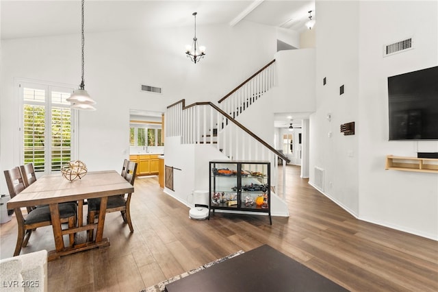 8612 Danza Del Sol Dr, Las Vegas, NV 89128 - dining room featuring wood finished floors, stairs, high vaulted ceiling, a chandelier, and beam ceiling