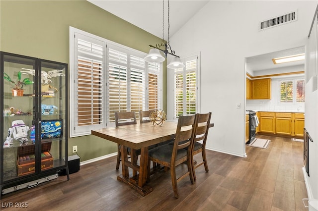 8612 Danza Del Sol Dr, Las Vegas, NV 89128 - dining space featuring wood finished floors, lofted ceiling, and baseboards