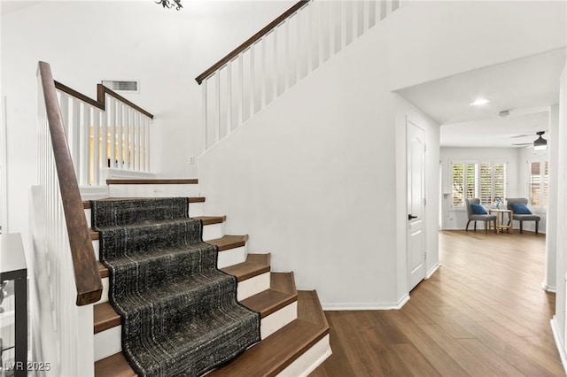 8612 Danza Del Sol Dr, Las Vegas, NV 89128 - staircase with wood finished floors, a high ceiling, a ceiling fan, and baseboards