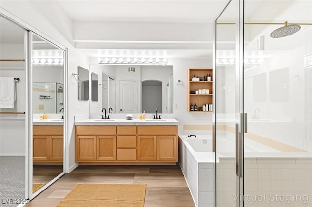 8612 Danza Del Sol Dr, Las Vegas, NV 89128 - full bath featuring double vanity, a stall shower, a bath, and wood finished floors