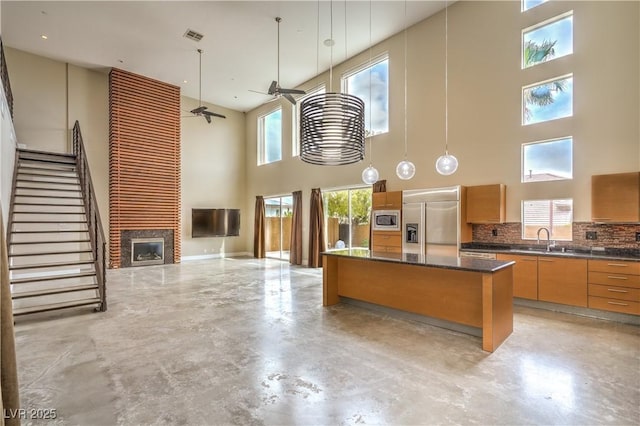 1448 Canyon Ledge Ct, Las Vegas, NV 89117 - kitchen featuring built in appliances, a high ceiling, open floor plan, finished concrete flooring, and a sink
