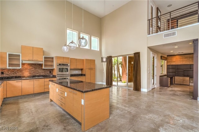 1448 Canyon Ledge Ct, Las Vegas, NV 89117 - kitchen with a towering ceiling, concrete flooring, stainless steel appliances, under cabinet range hood, and a kitchen island