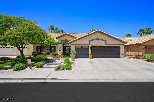 211 Kokopelli Ct, Henderson, NV 89074 - ranch-style house featuring an attached garage, stucco siding, driveway, and a tile roof