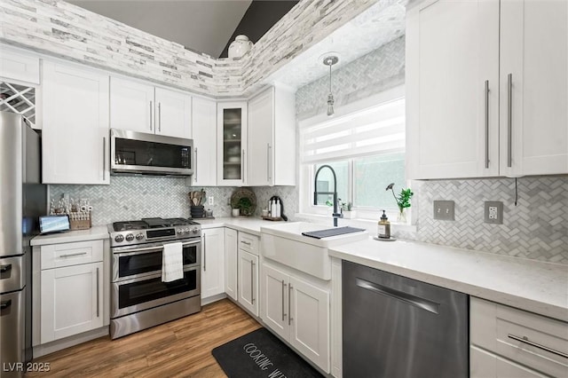 211 Kokopelli Ct, Henderson, NV 89074 - kitchen with appliances with stainless steel finishes, a sink, tasteful backsplash, white cabinetry, and light countertops