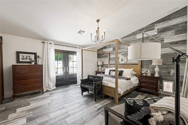 211 Kokopelli Ct, Henderson, NV 89074 - bedroom featuring vaulted ceiling, access to exterior, a chandelier, french doors, and wood finished floors