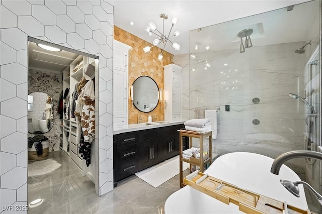 211 Kokopelli Ct, Henderson, NV 89074 - bathroom with marble tiled floors, a soaking tub, vanity, a shower stall, and tile walls