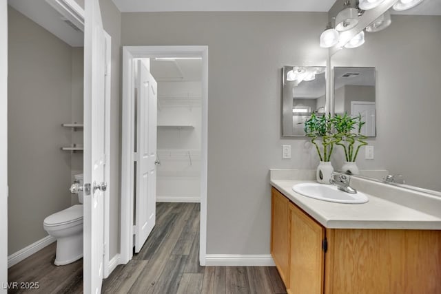 11787 Fern Creek Ln, Las Vegas, NV 89183 - bathroom with toilet, vanity, wood finished floors, and baseboards