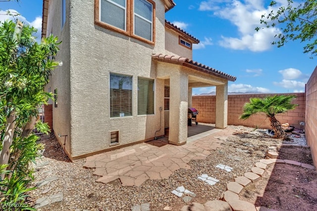 11787 Fern Creek Ln, Las Vegas, NV 89183 - back of property featuring stucco siding, a patio, a fenced backyard, and a tiled roof