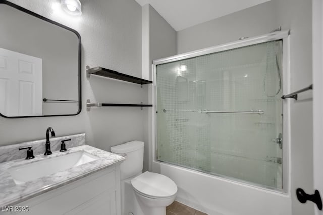 11787 Fern Creek Ln, Las Vegas, NV 89183 - bathroom featuring vanity, toilet, bath / shower combo with glass door, and tile patterned flooring