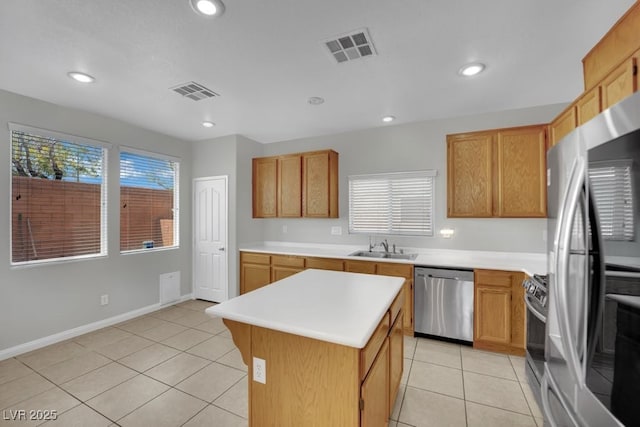 11787 Fern Creek Ln, Las Vegas, NV 89183 - kitchen with appliances with stainless steel finishes, a sink, a center island, light tile patterned flooring, and recessed lighting