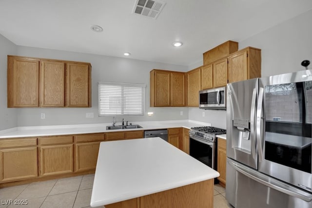 11787 Fern Creek Ln, Las Vegas, NV 89183 - kitchen featuring stainless steel appliances, a sink, light tile patterned floors, light countertops, and a kitchen island