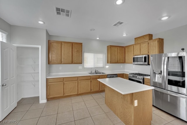 11787 Fern Creek Ln, Las Vegas, NV 89183 - kitchen with stainless steel appliances, a sink, light countertops, light tile patterned floors, and recessed lighting