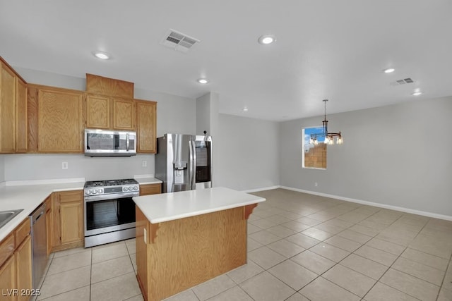 11787 Fern Creek Ln, Las Vegas, NV 89183 - kitchen featuring appliances with stainless steel finishes, light tile patterned floors, light countertops, a center island, and recessed lighting