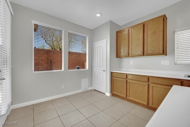 11787 Fern Creek Ln, Las Vegas, NV 89183 - kitchen featuring light countertops, baseboards, and light tile patterned flooring