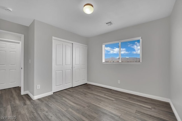 11787 Fern Creek Ln, Las Vegas, NV 89183 - unfurnished bedroom featuring wood finished floors, baseboards, and a closet