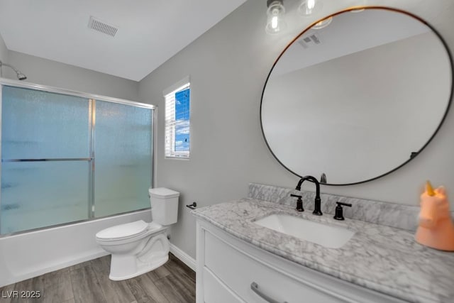 11787 Fern Creek Ln, Las Vegas, NV 89183 - full bathroom featuring vanity, toilet, wood finished floors, enclosed tub / shower combo, and baseboards