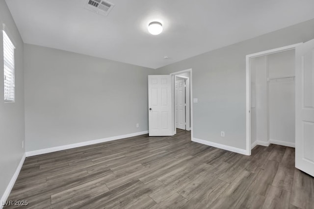 11787 Fern Creek Ln, Las Vegas, NV 89183 - unfurnished bedroom featuring dark wood-type flooring, baseboards, and a closet