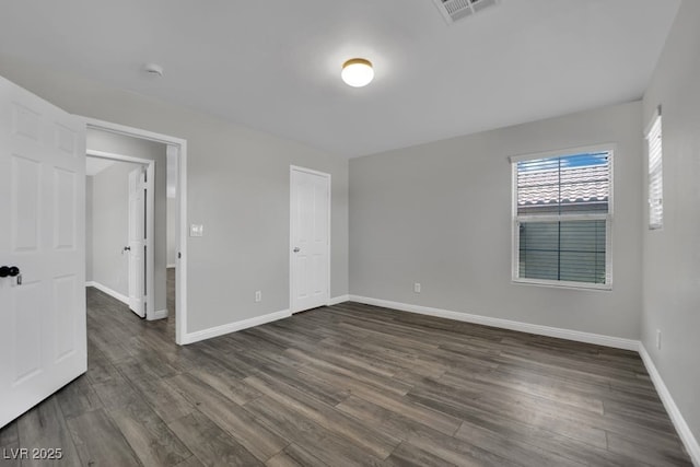 11787 Fern Creek Ln, Las Vegas, NV 89183 - unfurnished bedroom featuring dark wood finished floors and baseboards