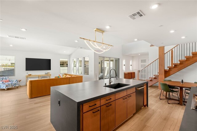 2578 Skylark Trail St, Henderson, NV 89044 - kitchen with a sink, stainless steel dishwasher, light wood finished floors, a center island with sink, and dark countertops