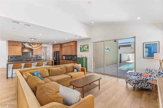 2578 Skylark Trail St, Henderson, NV 89044 - living room with light wood-style flooring, lofted ceiling, and recessed lighting