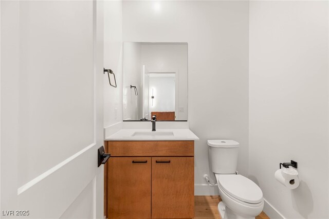 2578 Skylark Trail St, Henderson, NV 89044 - bathroom with toilet, vanity, baseboards, and wood finished floors