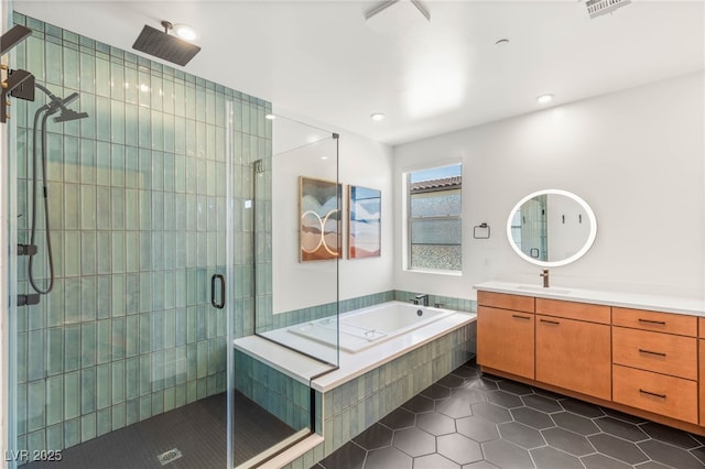 2578 Skylark Trail St, Henderson, NV 89044 - full bathroom with tile patterned floors, a shower stall, vanity, a garden tub, and recessed lighting
