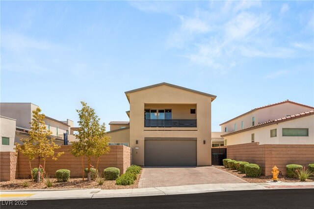 2578 Skylark Trail St, Henderson, NV 89044 - view of front of home with a balcony, decorative driveway, a garage, and stucco siding