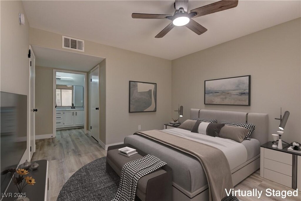 5710 E Tropicana Ave Unit 1216, Las Vegas, NV 89122 - bedroom with light wood finished floors, baseboards, and a ceiling fan