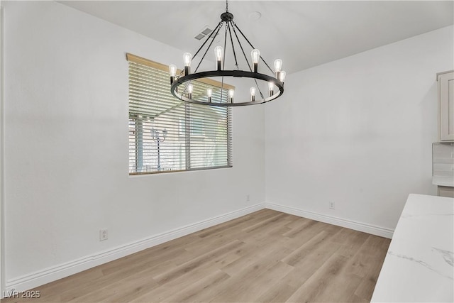 576 Foster Springs Rd, Las Vegas, NV 89148 - unfurnished dining area featuring a chandelier, light wood finished floors, and baseboards