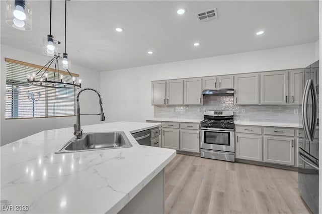 576 Foster Springs Rd, Las Vegas, NV 89148 - kitchen with appliances with stainless steel finishes, a sink, under cabinet range hood, gray cabinetry, and recessed lighting