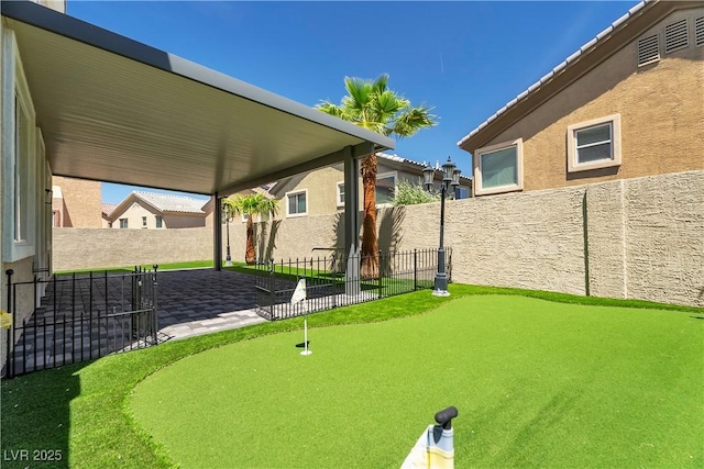 576 Foster Springs Rd, Las Vegas, NV 89148 - fenced backyard with an area to practice putting and a patio