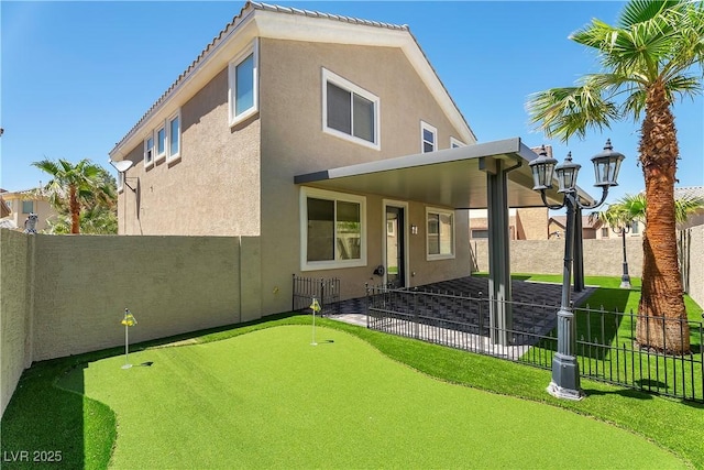 576 Foster Springs Rd, Las Vegas, NV 89148 - back of house with a putting area, a fenced backyard, stucco siding, and a patio