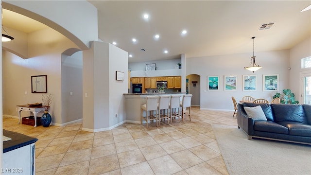 2713 Tanagrine Dr, North Las Vegas, NV 89084 - living area featuring arched walkways, light tile patterned flooring, recessed lighting, and baseboards