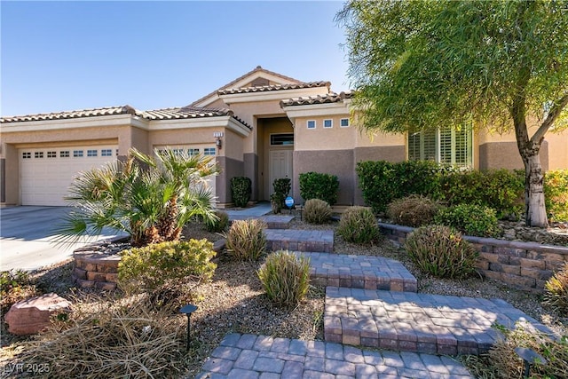2713 Tanagrine Dr, North Las Vegas, NV 89084 - view of front of home featuring stucco siding, a garage, driveway, and a tiled roof