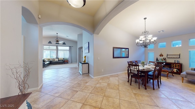 2713 Tanagrine Dr, North Las Vegas, NV 89084 - dining room with vaulted ceiling, arched walkways, a ceiling fan, a chandelier, and baseboards