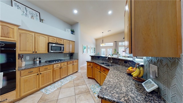 2713 Tanagrine Dr, North Las Vegas, NV 89084 - kitchen featuring appliances with stainless steel finishes, a sink, backsplash, dark stone countertops, and light tile patterned floors