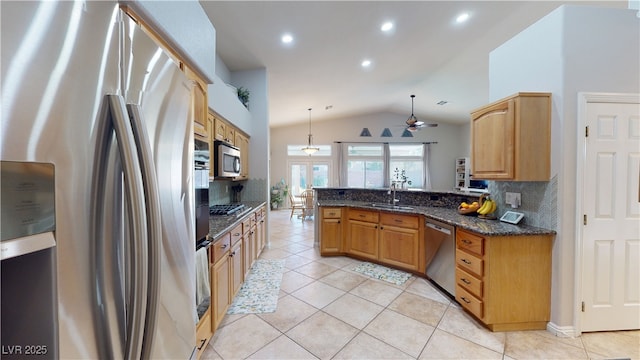 2713 Tanagrine Dr, North Las Vegas, NV 89084 - kitchen featuring stainless steel appliances, vaulted ceiling, a peninsula, a sink, and ceiling fan