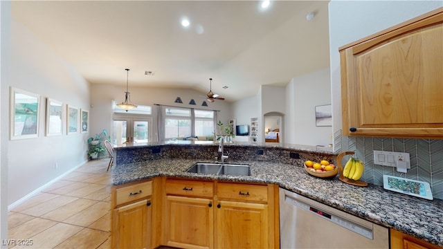2713 Tanagrine Dr, North Las Vegas, NV 89084 - kitchen featuring stainless steel dishwasher, a sink, decorative backsplash, dark stone countertops, and light tile patterned floors