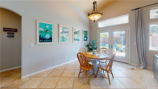 2713 Tanagrine Dr, North Las Vegas, NV 89084 - dining room featuring light tile patterned floors, plenty of natural light, french doors, high vaulted ceiling, and baseboards