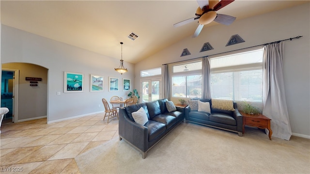 2713 Tanagrine Dr, North Las Vegas, NV 89084 - living room featuring vaulted ceiling, arched walkways, a ceiling fan, and baseboards