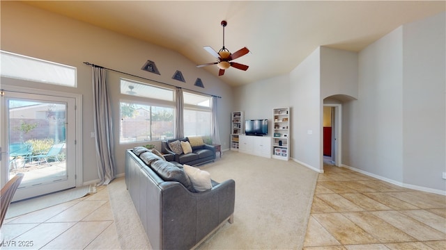2713 Tanagrine Dr, North Las Vegas, NV 89084 - living area featuring arched walkways, ceiling fan, light tile patterned floors, baseboards, and light carpet