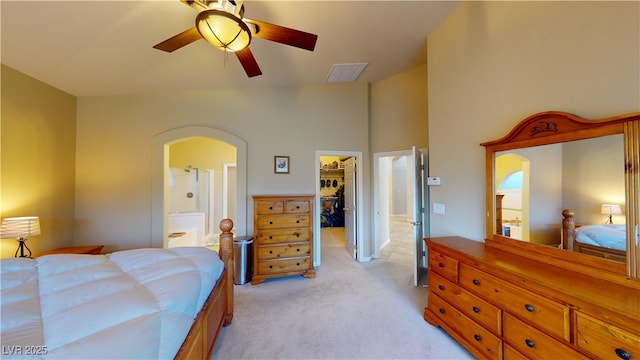 2713 Tanagrine Dr, North Las Vegas, NV 89084 - bedroom featuring a spacious closet, light colored carpet, arched walkways, a closet, and vaulted ceiling