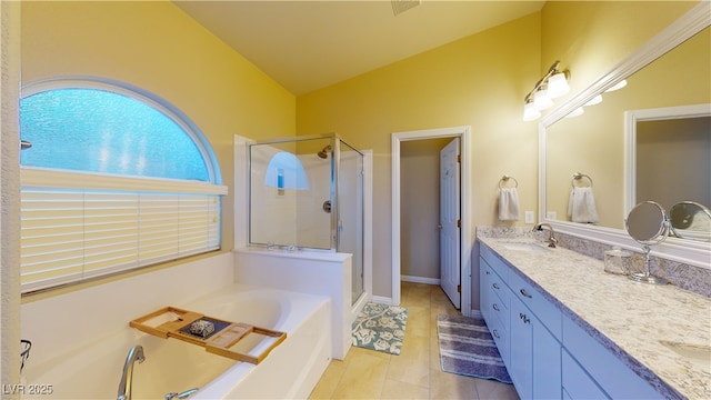 2713 Tanagrine Dr, North Las Vegas, NV 89084 - full bath featuring a stall shower, double vanity, a garden tub, lofted ceiling, and tile patterned floors