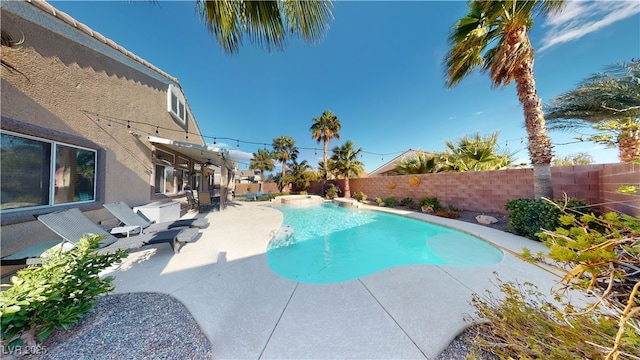 2713 Tanagrine Dr, North Las Vegas, NV 89084 - view of swimming pool featuring a fenced backyard, a patio, and a pool with connected hot tub