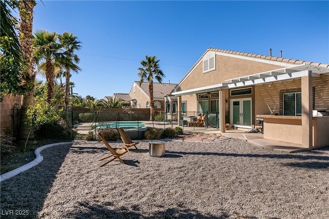2713 Tanagrine Dr, North Las Vegas, NV 89084 - fenced backyard featuring french doors, a patio area, and a pergola