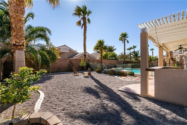 2713 Tanagrine Dr, North Las Vegas, NV 89084 - fenced backyard featuring ceiling fan, a patio, and a pergola