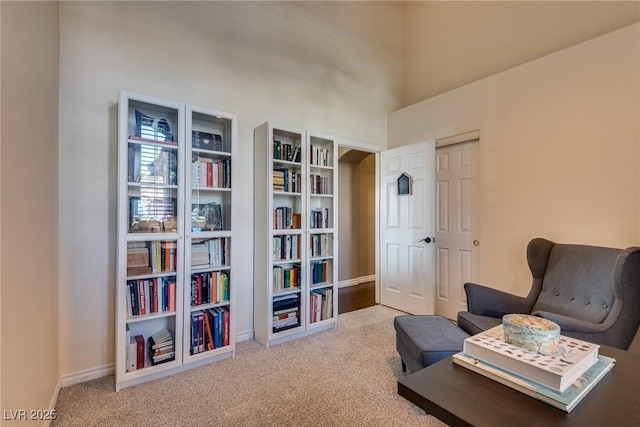 3088 Paseo Mountain Ave, Henderson, NV 89052 - sitting room with carpet floors, a towering ceiling, and baseboards