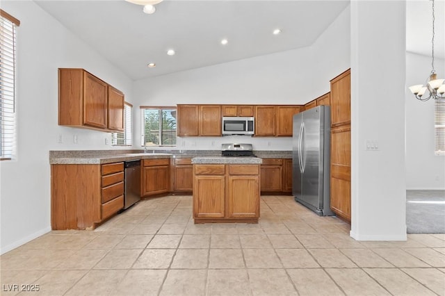 3273 Alcudia Bay Ave, Las Vegas, NV 89141 - kitchen with appliances with stainless steel finishes, high vaulted ceiling, light tile patterned floors, brown cabinetry, and a chandelier